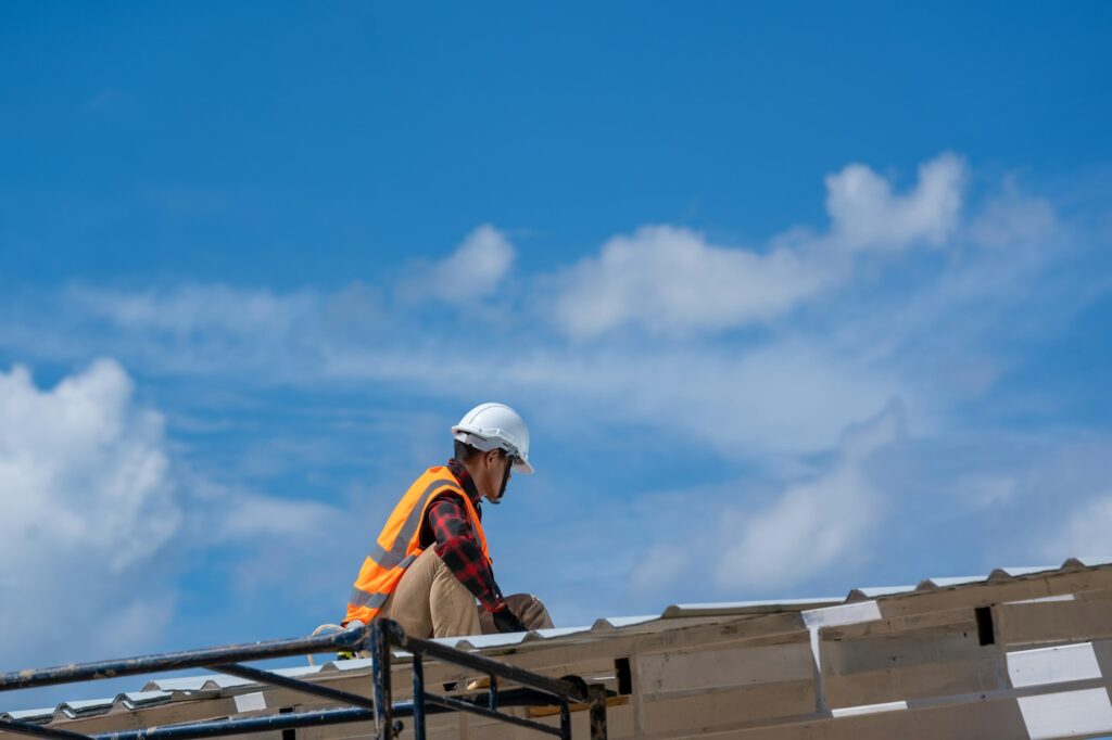 Roofing,Construction workers wearing safety harness checking and installation assembly of roof.